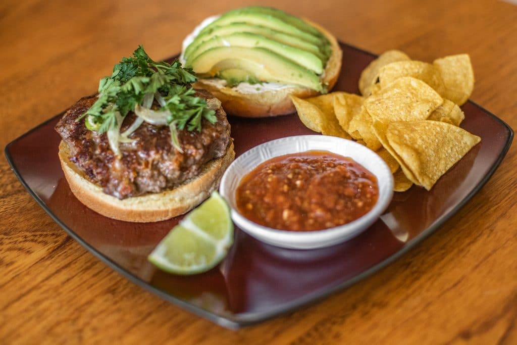 taco burgers with toppings on a plate