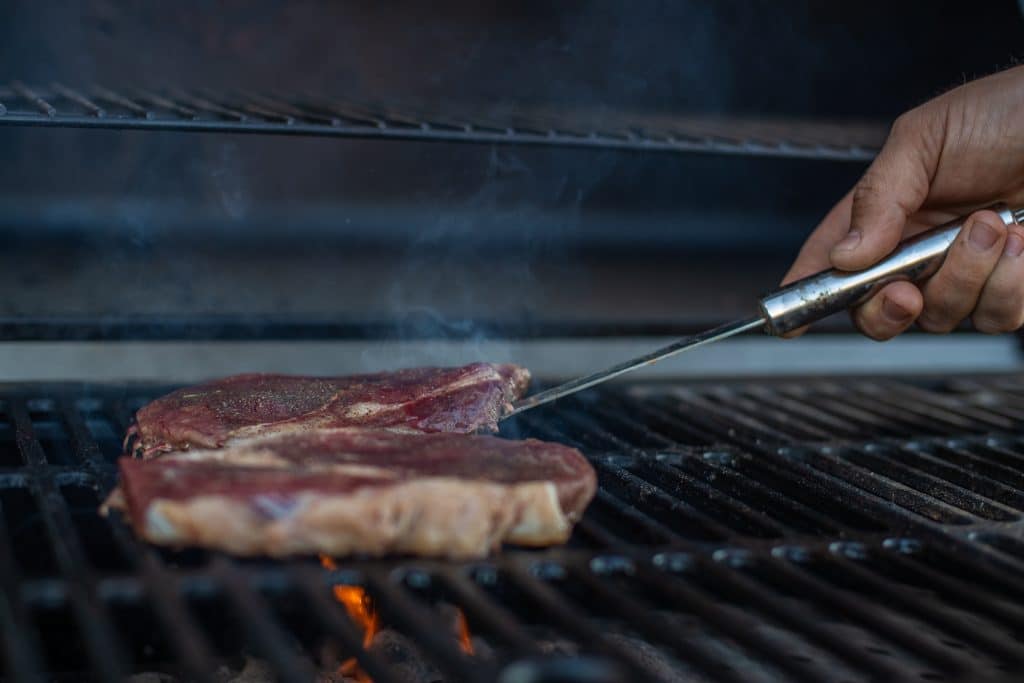 A ribeye steak on the grill.