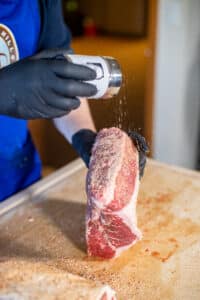 brisket being seasoned
