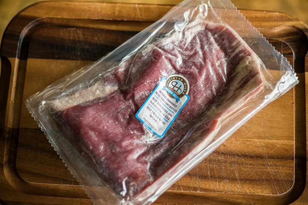Why should you slow thaw frozen meat?