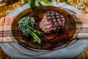 grass-fed beef filets on a plate with broccoli
