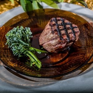 grass-fed beef filets on a plate with broccoli